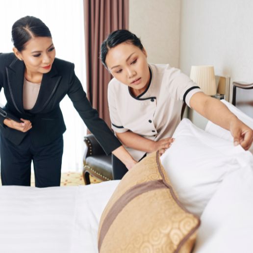 Hotel manager inspecting room quality with staff, reflecting hospitality excellence and brand promotion through effective Digital Marketing Services in India.