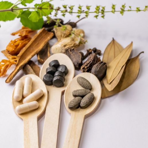 Natural Ayurvedic herbs and supplements on wooden spoons representing holistic branding through digital marketing services in India.
