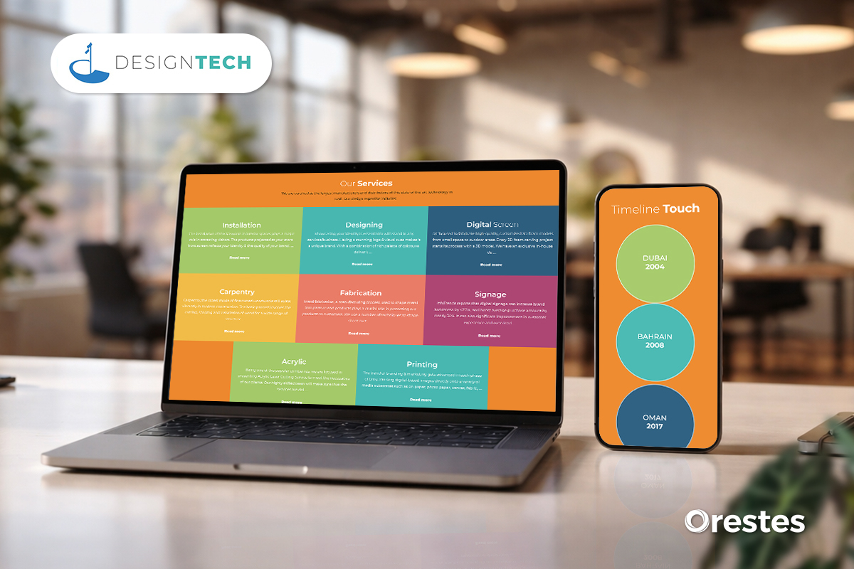 A tablet and smartphone on a wooden desk in a busy office setting, both displaying a dark-themed "Our Services" page for Design Tech. Services include Digital Screen solutions, Designing, Installation, and High-Quality Printing.