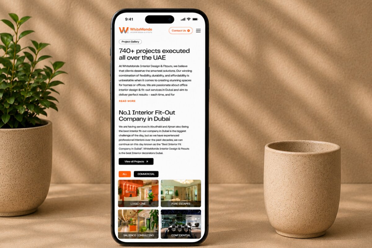 Smartphone displaying the WhiteMonde mobile website with project gallery, commercial interior design portfolio, and office fit-out projects.