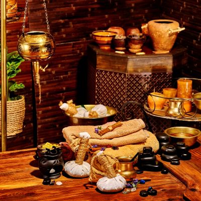 Ayurvedic spa setup with herbal oils, towels, and traditional decor showcasing wellness promotion through digital marketing services in India.